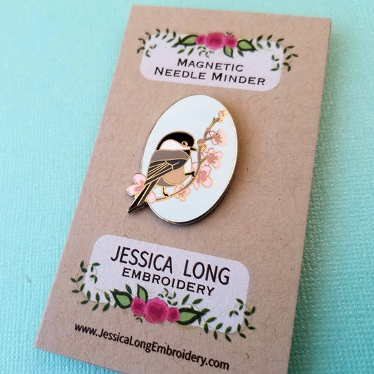 Chickadee Enamel Needle Minder with floral design on brown card