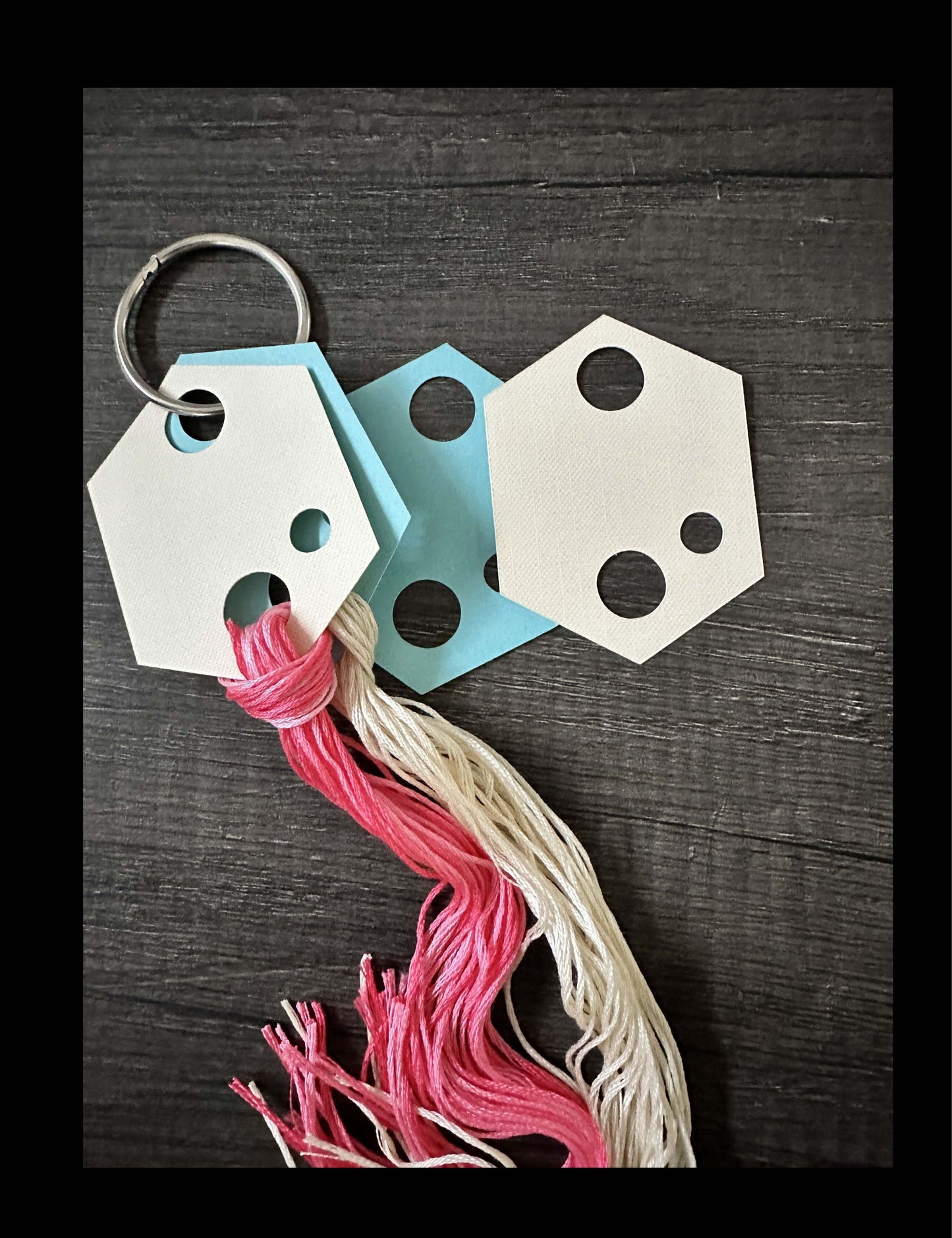 Hexagon Embroidery Cross Stitch Floss Holders Thread Drops displaying pink and white threads on a key ring.