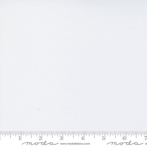 White Moda fabric square with ruler for scale.