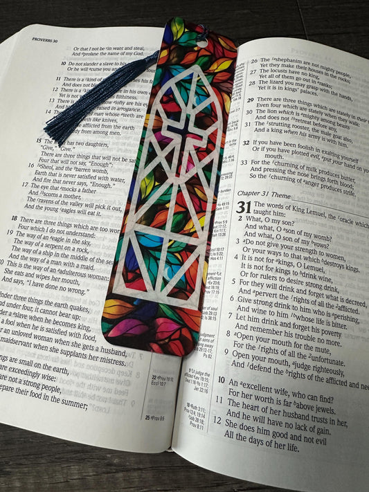 Bookmarks Faith Cross Looks Like Stained Glass Amazing Grace bookmark laying on open Bible with tassel visible.