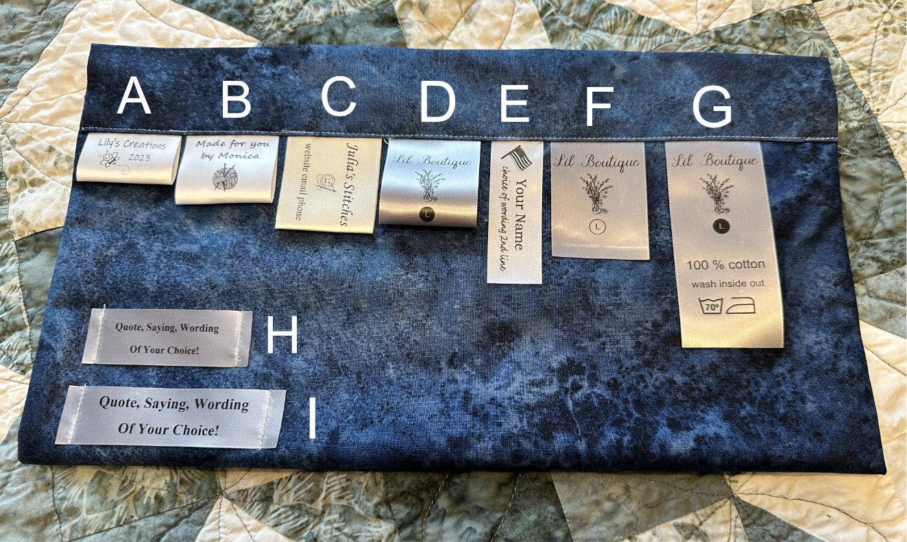 Display of customizable satin ribbon labels for clothing and accessories, featuring various designs and text options on a dark fabric background.