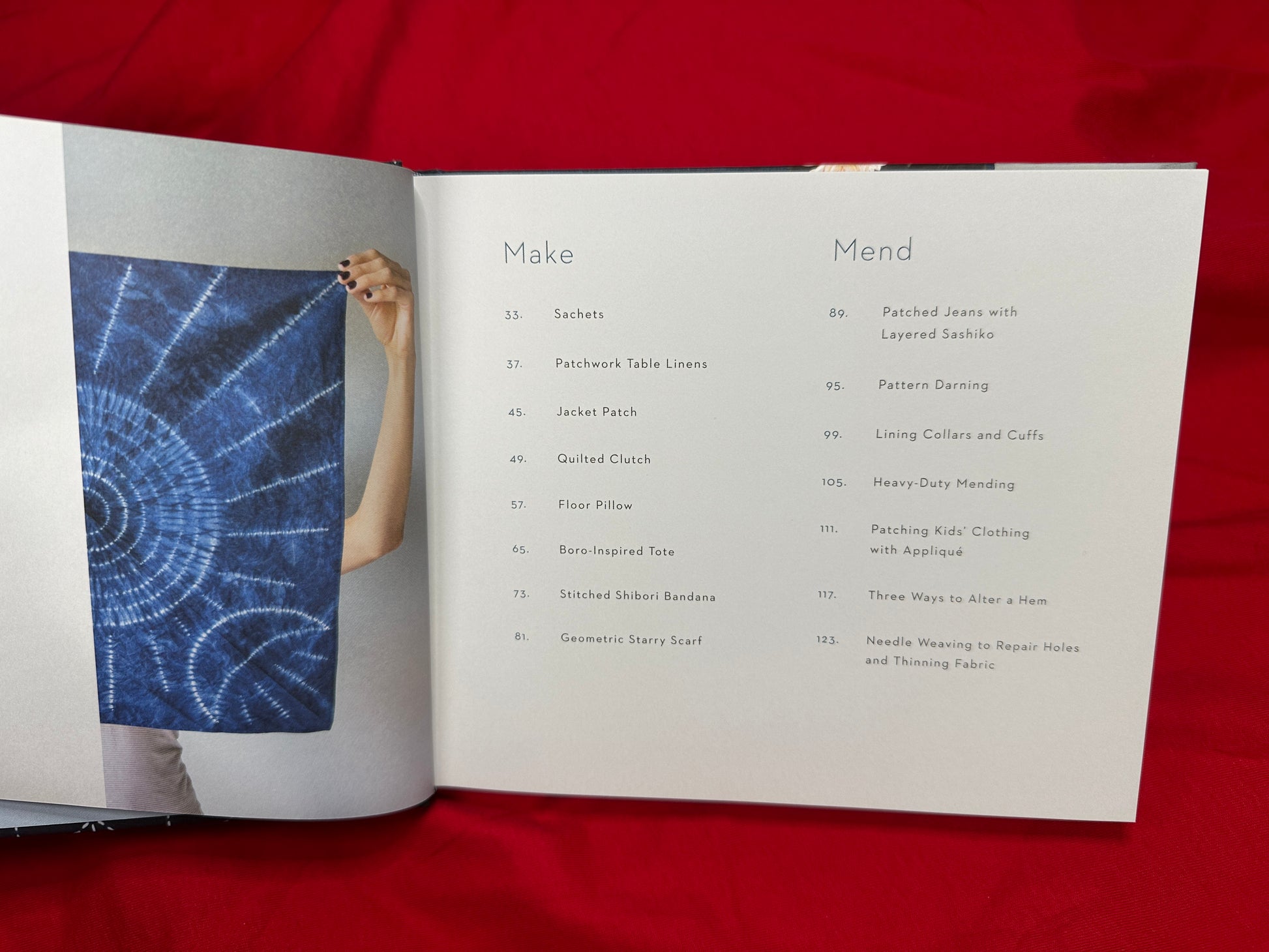 Open book displaying 'Make and Mend' table of contents and hand-sewn sashiko project for learning sashiko techniques.