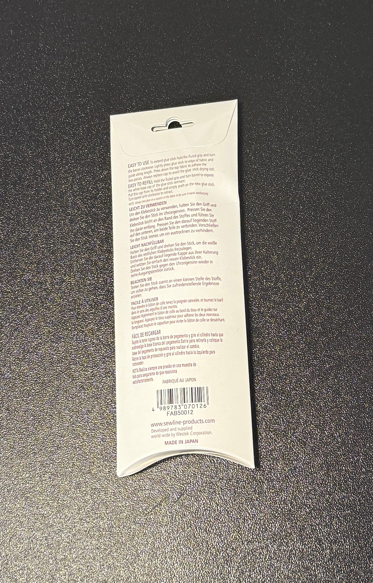 Packaging of Water Soluble Glue Pen FAB50012 Pink Pen Blue Glue that dries clear, showing the product details and instructions.