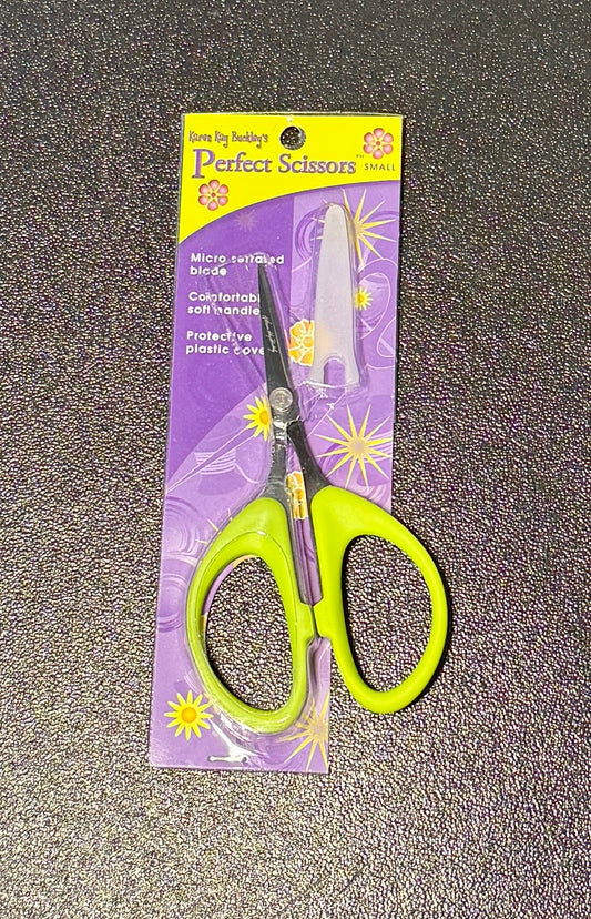 Perfect Scissors in green with micro-serrated fabric scissors for non-slip, precise cutting, packaged on a colorful background.