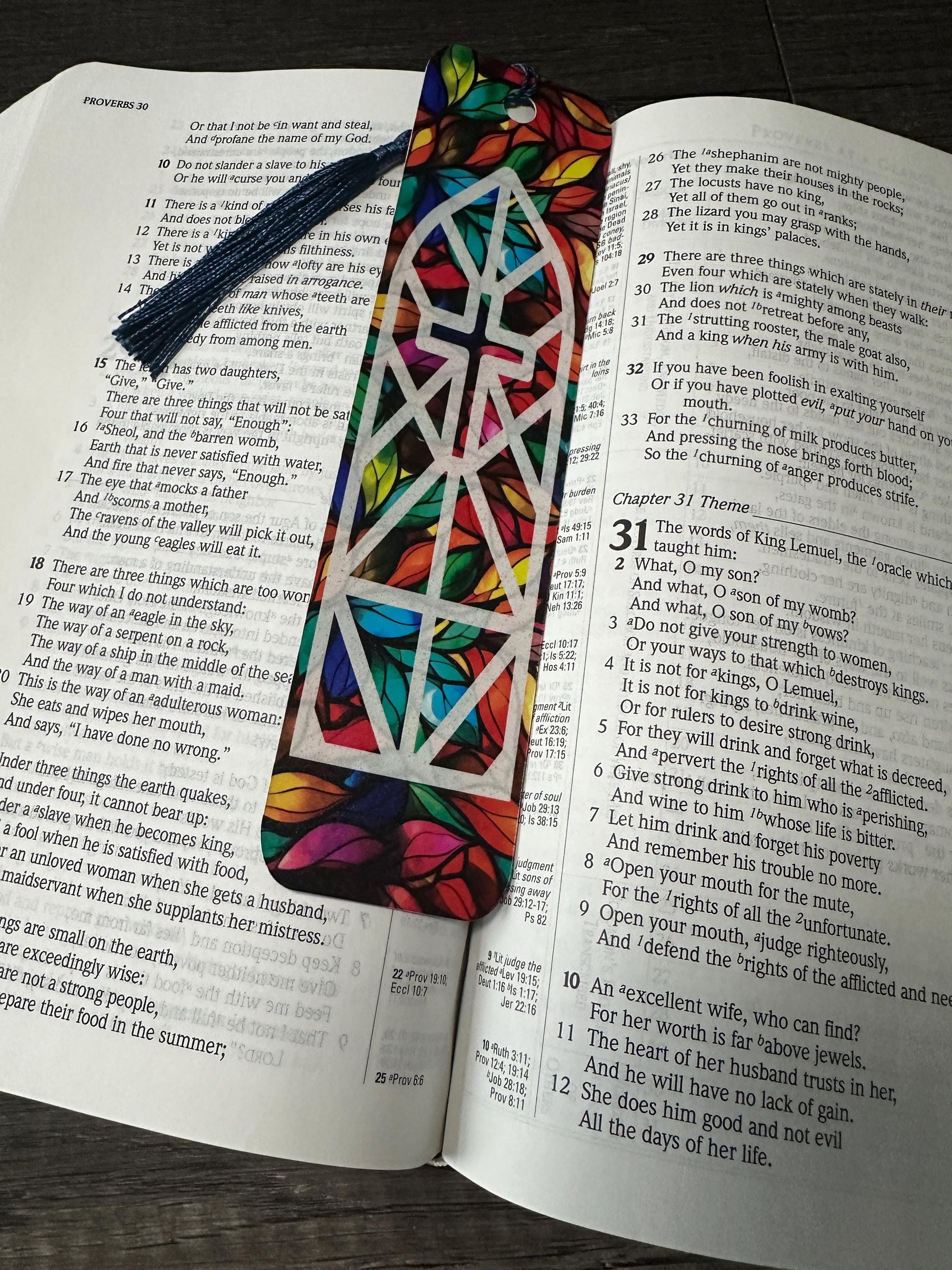 Bookmarks Faith Cross Looks Like Stained Glass Amazing Grace bookmark laying on open Bible with tassel visible.
