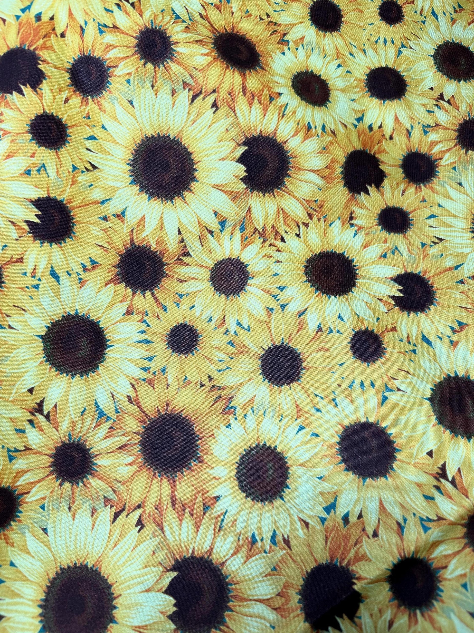 Sunflower Garden Cotton Fabric with vibrant sunflower pattern, 100% cotton, ideal for sewing and crafts, 44"-45" wide.