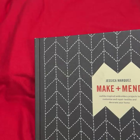 Book titled 'Make and Mend' about sashiko sewing technique, ideal for learning and decorative projects.